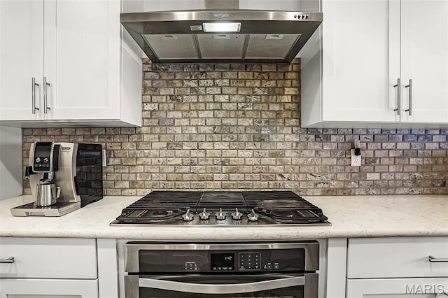 1420 Randle St, Edwardsville, IL 62025 - kitchen with range hood, stainless steel oven, gas cooktop, backsplash, and white cabinetry