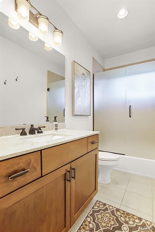 1420 Randle St, Edwardsville, IL 62025 - bathroom featuring vanity, tile patterned flooring, toilet, and enclosed tub / shower combo