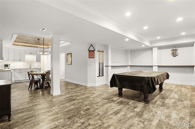 1420 Randle St, Edwardsville, IL 62025 - game room featuring a raised ceiling, crown molding, wood finished floors, baseboards, and recessed lighting