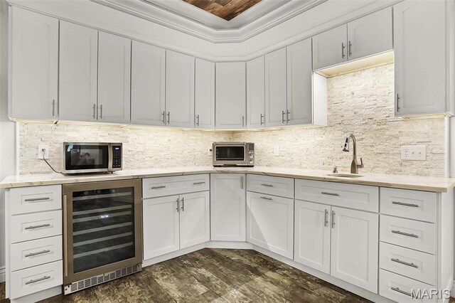 1420 Randle St, Edwardsville, IL 62025 - kitchen with beverage cooler, stainless steel microwave, a sink, dark wood finished floors, and white cabinetry