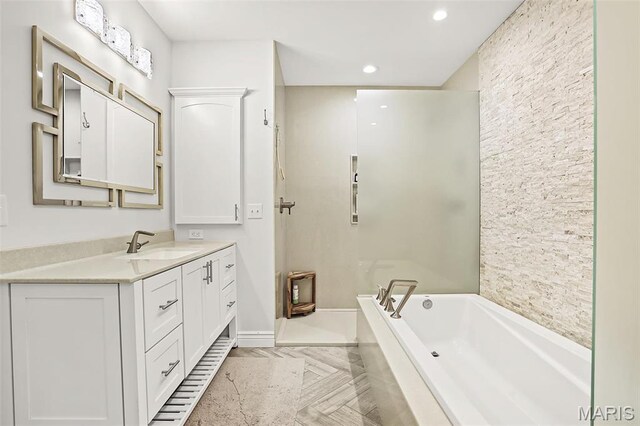 1420 Randle St, Edwardsville, IL 62025 - bathroom featuring vanity, a garden tub, recessed lighting, and baseboards