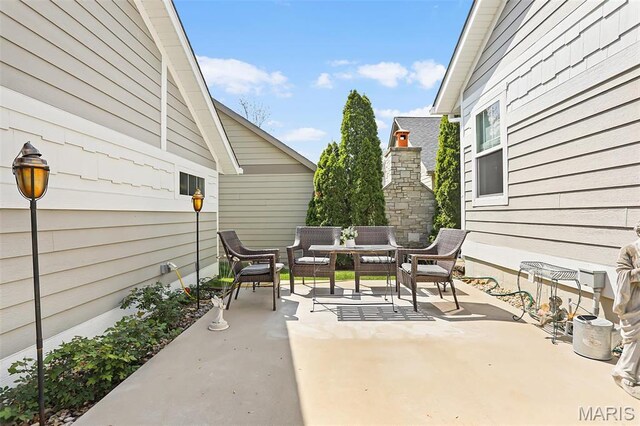 1420 Randle St, Edwardsville, IL 62025 - view of patio with an outdoor living space with a fireplace