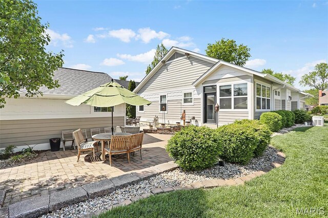 1420 Randle St, Edwardsville, IL 62025 - back of house featuring a patio area, a lawn, and a shingled roof