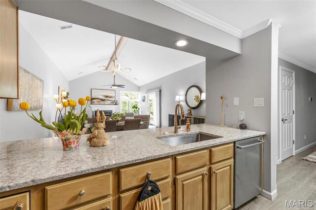 kitchen with a sink, dishwasher, light stone countertops, light wood-style flooring, and lofted ceiling