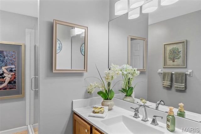 bathroom featuring a shower stall and vanity