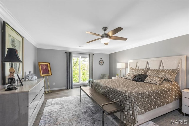 bedroom featuring ornamental molding, wood finished floors, baseboards, and a ceiling fan
