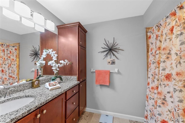full bath with baseboards, vanity, and curtained shower