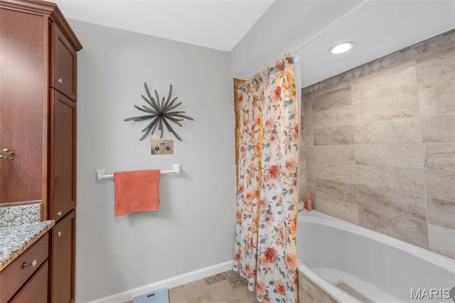 bathroom featuring baseboards, vanity, shower / tub combo, and recessed lighting