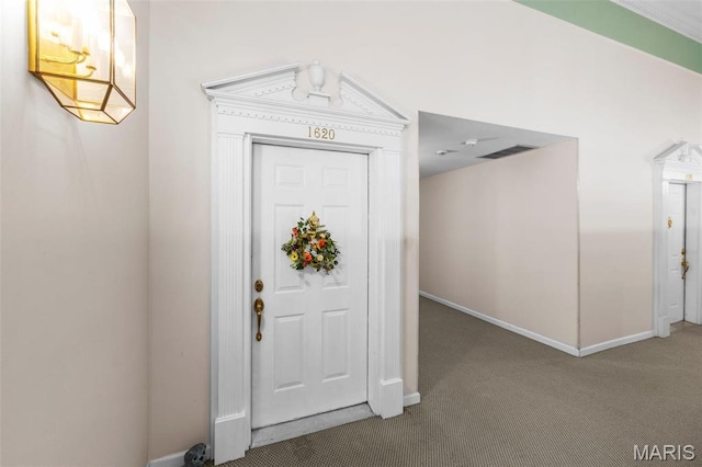 carpeted entrance foyer featuring baseboards