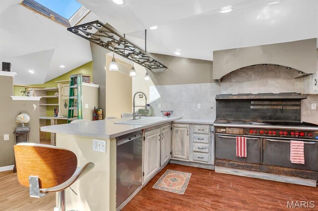 14742 Madison Ln, Wright City, MO 63390 - kitchen with a sink, stainless steel appliances, exhaust hood, a skylight, and wood finished floors