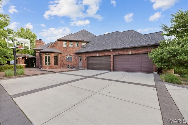 10711 Kennerly Rd, Saint Louis, MO 63128 - view of front of house featuring brick siding, concrete driveway, an attached garage, and a shingled roof
