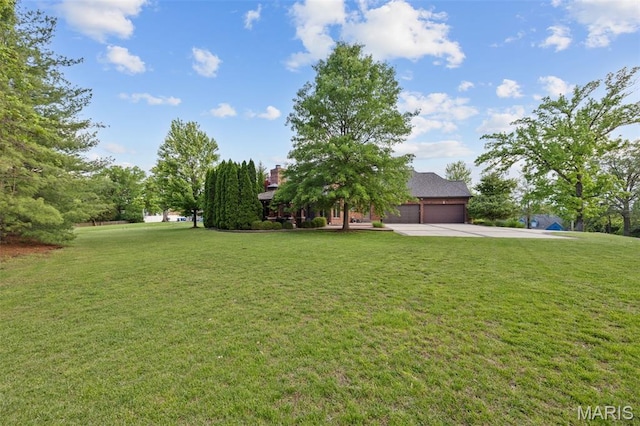 10711 Kennerly Rd, Saint Louis, MO 63128 - view of grassy yard with driveway and an attached garage