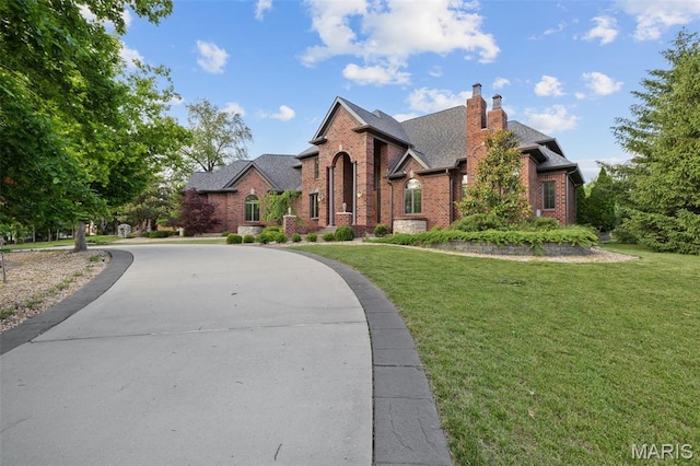 10711 Kennerly Rd, Saint Louis, MO 63128 - traditional home with brick siding, a chimney, a front yard, and a shingled roof
