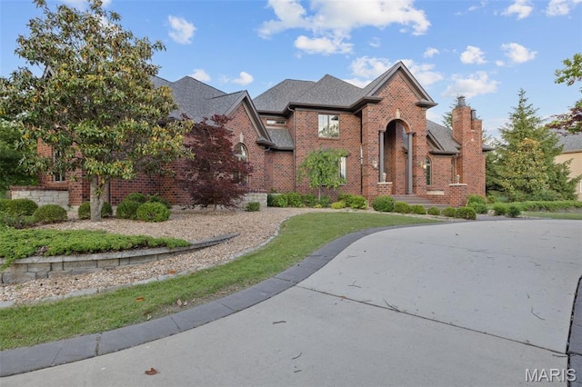 10711 Kennerly Rd, Saint Louis, MO 63128 - traditional-style house with brick siding and a chimney