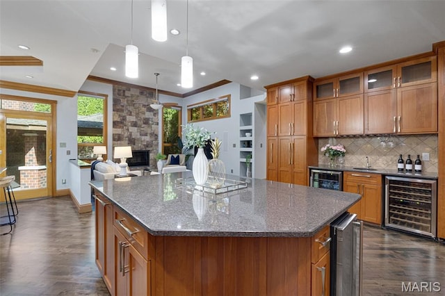 10711 Kennerly Rd, Saint Louis, MO 63128 - kitchen featuring wine cooler, brown cabinets, dark wood finished floors, crown molding, and decorative backsplash