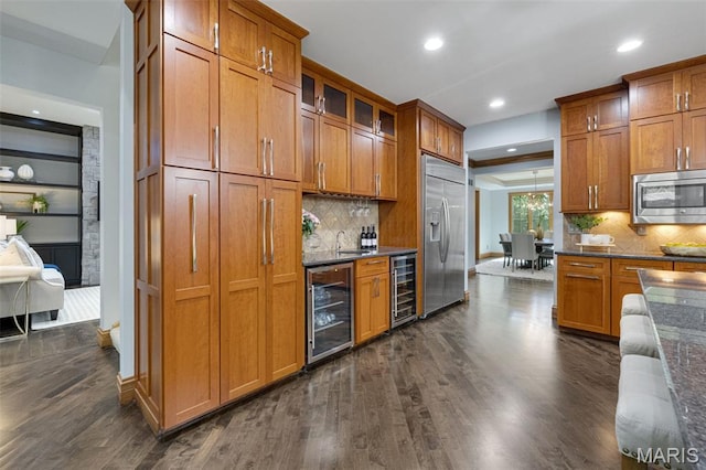 10711 Kennerly Rd, Saint Louis, MO 63128 - kitchen with wine cooler, built in appliances, brown cabinetry, and recessed lighting