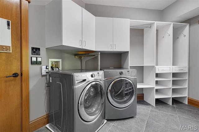 10711 Kennerly Rd, Saint Louis, MO 63128 - washroom featuring cabinet space, independent washer and dryer, light tile patterned floors, and baseboards