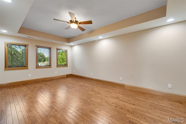 10711 Kennerly Rd, Saint Louis, MO 63128 - unfurnished room featuring a ceiling fan, recessed lighting, light wood finished floors, baseboards, and a raised ceiling