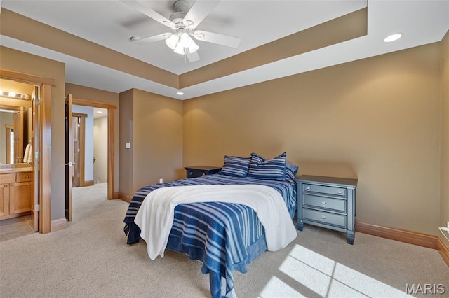 10711 Kennerly Rd, Saint Louis, MO 63128 - bedroom with light carpet, baseboards, recessed lighting, a tray ceiling, and ensuite bath