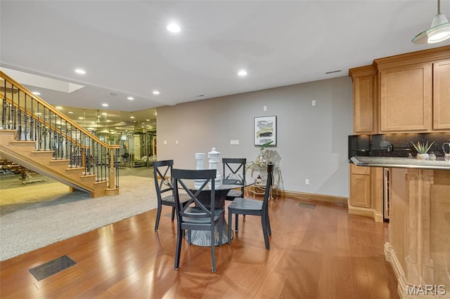 10711 Kennerly Rd, Saint Louis, MO 63128 - dining space featuring stairway, light wood-style floors, baseboards, and recessed lighting
