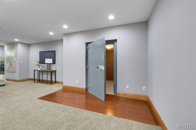 10711 Kennerly Rd, Saint Louis, MO 63128 - unfurnished living room featuring carpet floors, recessed lighting, baseboards, and wood finished floors