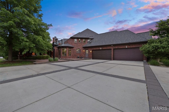 10711 Kennerly Rd, Saint Louis, MO 63128 - view of front of home with brick siding, driveway, an attached garage, and a shingled roof