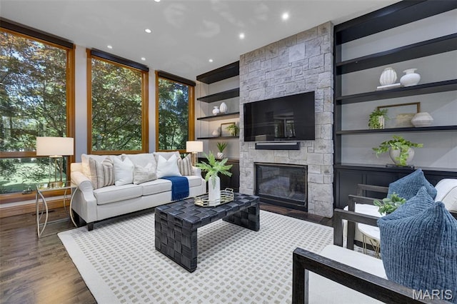 10711 Kennerly Rd, Saint Louis, MO 63128 - living area featuring wood finished floors, a fireplace, a wall of windows, recessed lighting, and built in shelves
