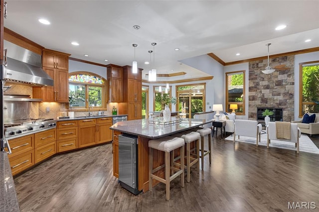 10711 Kennerly Rd, Saint Louis, MO 63128 - kitchen with wine cooler, crown molding, wall chimney exhaust hood, stainless steel appliances, and dark wood-style flooring