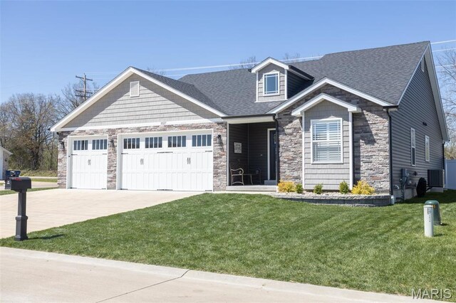 1027 Watering Stone Ct, Pevely, MO 63070 - craftsman inspired home with a garage, driveway, a front yard, a shingled roof, and stone siding