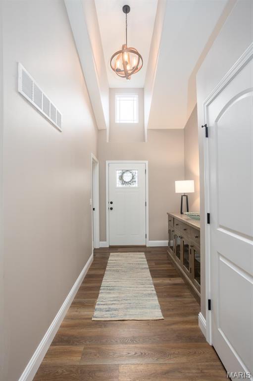1027 Watering Stone Ct, Pevely, MO 63070 - entrance foyer with a chandelier, wood finished floors, and baseboards