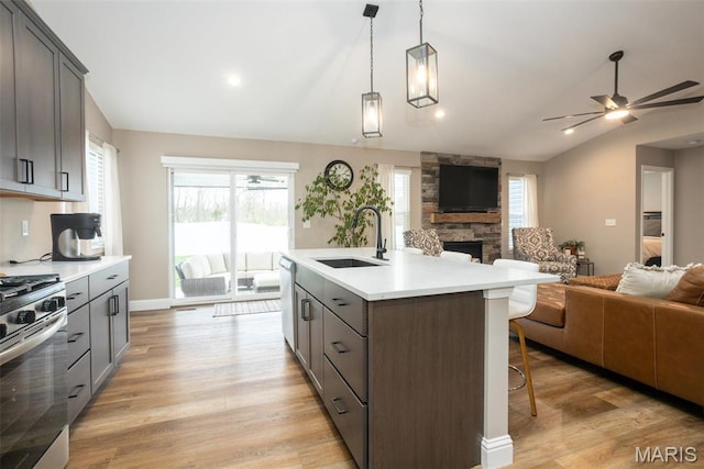 1027 Watering Stone Ct, Pevely, MO 63070 - kitchen featuring a sink, open floor plan, stainless steel gas range, gray cabinets, and lofted ceiling