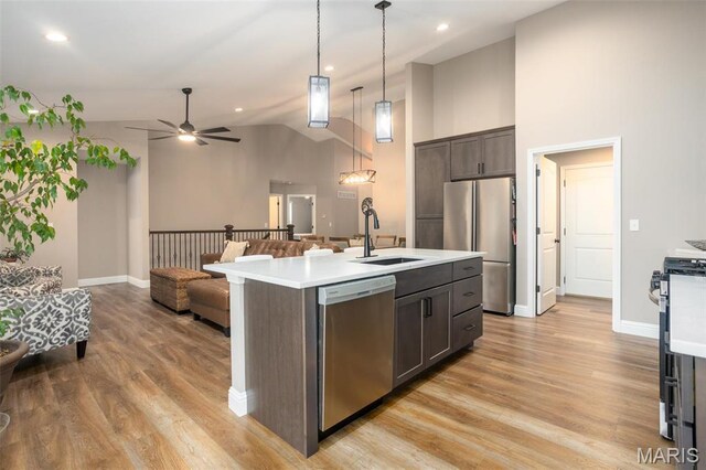 1027 Watering Stone Ct, Pevely, MO 63070 - kitchen with appliances with stainless steel finishes, a sink, open floor plan, light countertops, and high vaulted ceiling