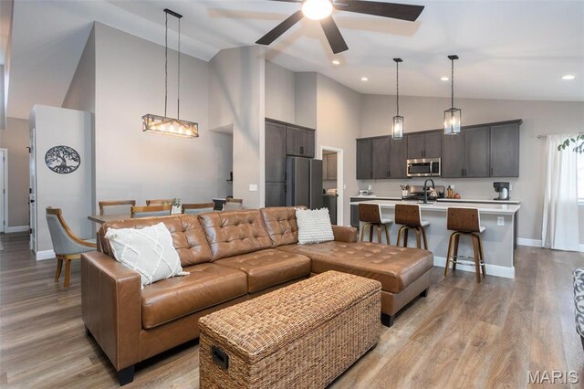 1027 Watering Stone Ct, Pevely, MO 63070 - living room featuring high vaulted ceiling, baseboards, a ceiling fan, and light wood-type flooring