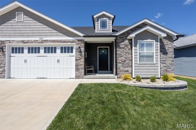 1027 Watering Stone Ct, Pevely, MO 63070 - craftsman inspired home with stone siding, a front lawn, an attached garage, and driveway