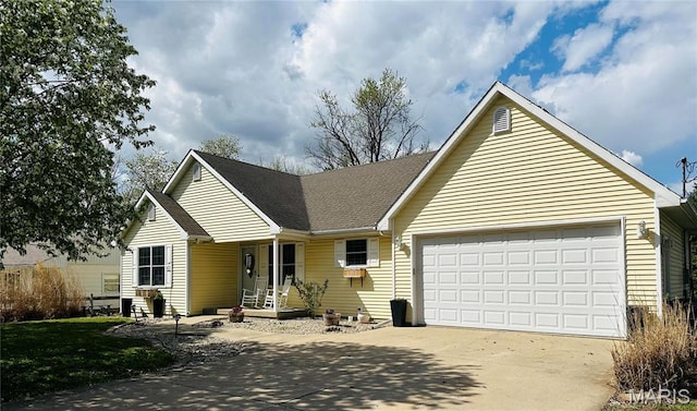 view of front facade featuring concrete driveway, an attached garage, covered porch, and a shingled roof