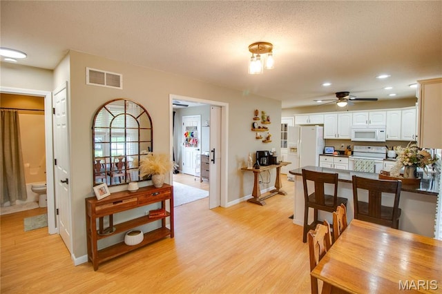 dining room featuring a ceiling fan, light wood-style flooring, baseboards, and recessed lighting