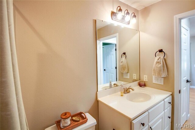 bathroom featuring vanity and toilet