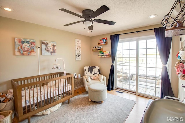 bedroom featuring recessed lighting, a textured ceiling, ceiling fan, and wood finished floors