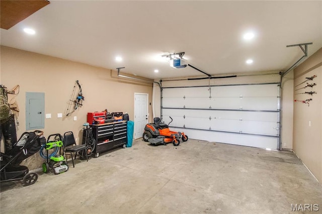 garage with electric panel, recessed lighting, and a garage door opener