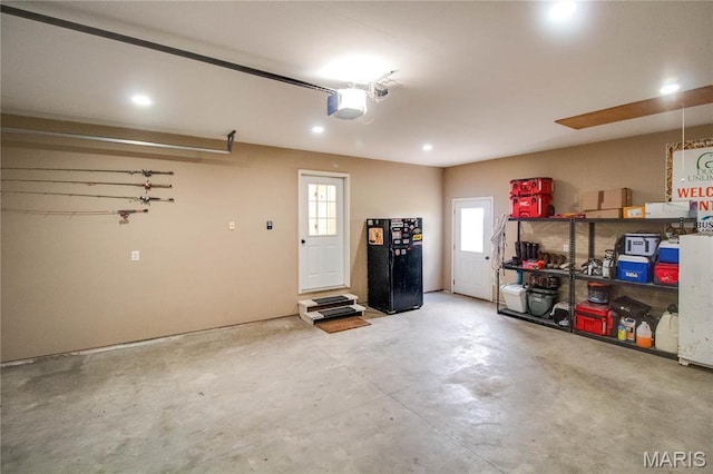 garage with a garage door opener and recessed lighting