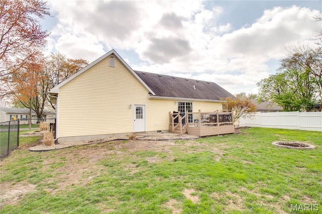 back of house with a wooden deck, an outdoor fire pit, and roof with shingles