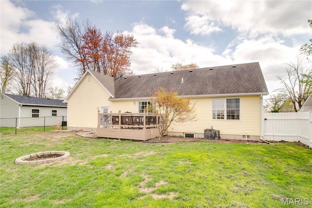 back of house with a wooden deck, roof with shingles, central air condition unit, and an outdoor fire pit