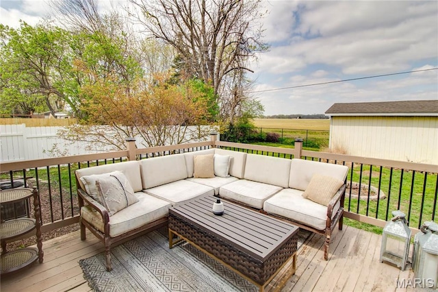 wooden terrace featuring outdoor lounge area and a fenced backyard