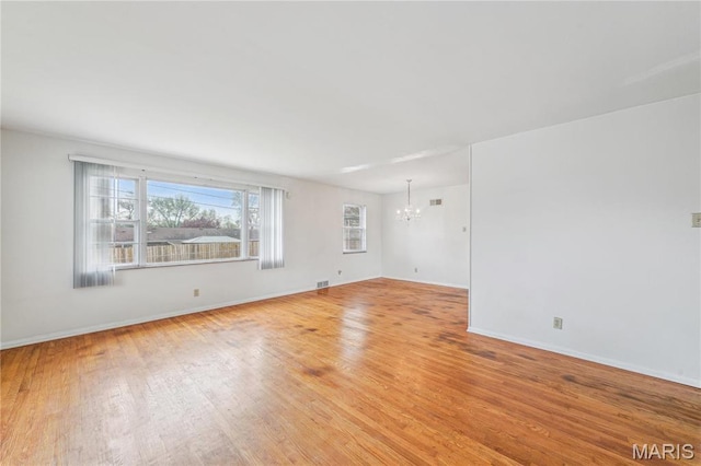 11562 Rock Hampton Dr, Saint Louis, MO 63138 - unfurnished room featuring a chandelier, light wood finished floors, and baseboards