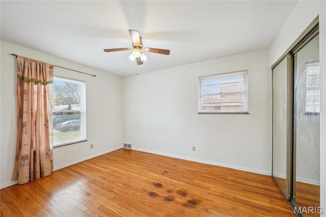 11562 Rock Hampton Dr, Saint Louis, MO 63138 - unfurnished bedroom featuring light wood finished floors, baseboards, a closet, and a ceiling fan