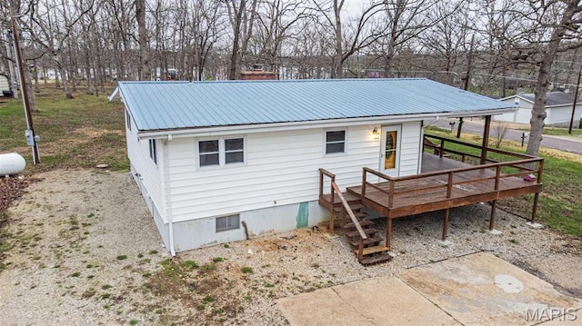 777 Squaw Rd, Cuba, MO 65453 - rear view of house with metal roof and a deck