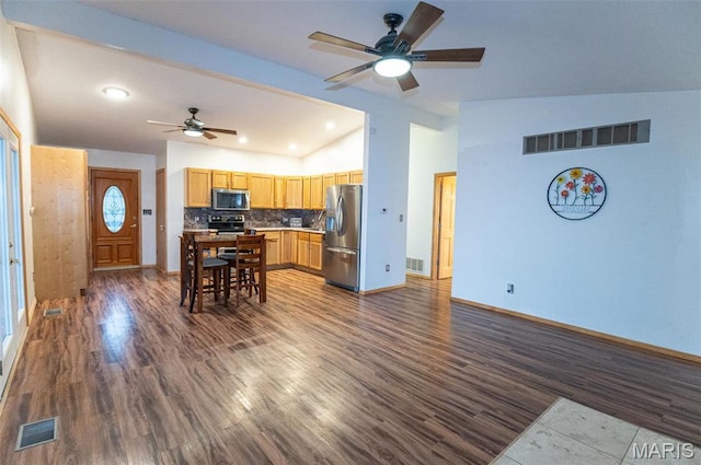 777 Squaw Rd, Cuba, MO 65453 - kitchen featuring appliances with stainless steel finishes, vaulted ceiling, a ceiling fan, dark wood-style floors, and baseboards