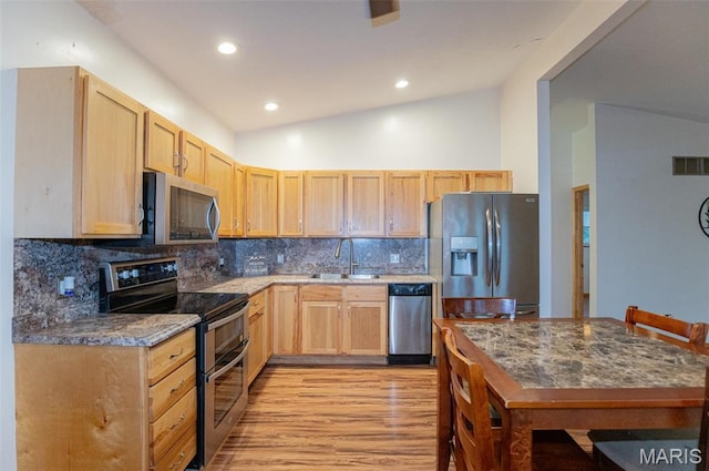 777 Squaw Rd, Cuba, MO 65453 - kitchen featuring appliances with stainless steel finishes, a sink, light brown cabinetry, light wood-style floors, and vaulted ceiling