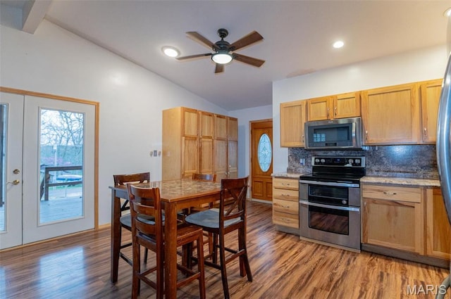 777 Squaw Rd, Cuba, MO 65453 - kitchen featuring appliances with stainless steel finishes, lofted ceiling, wood finished floors, backsplash, and ceiling fan