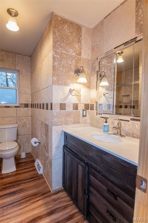 777 Squaw Rd, Cuba, MO 65453 - bathroom with tile walls, toilet, wood finished floors, and vanity